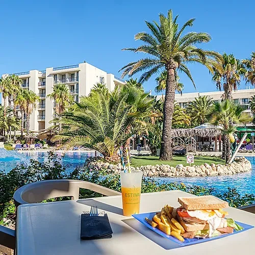 Enjoy a sandwich and drink by the pool at Estival Islantilla 4* in Huelva.
