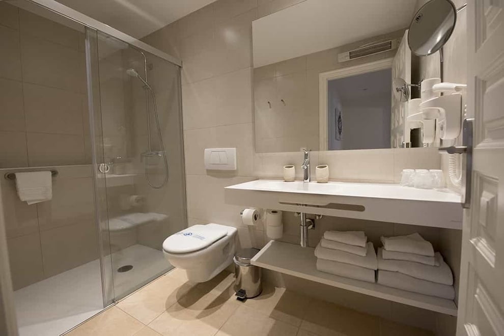 a bathroom with a toilet a sink and a mirror