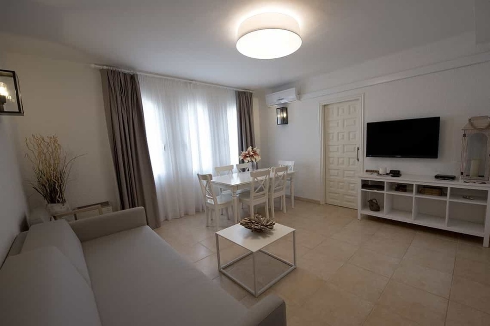 a living room with a couch a table and a television