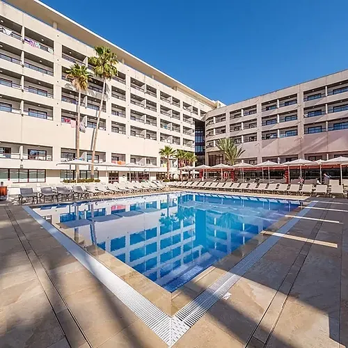 Estival Park Almaris | Estival Group | Tarragona hotel pool with sun loungers and palm trees.