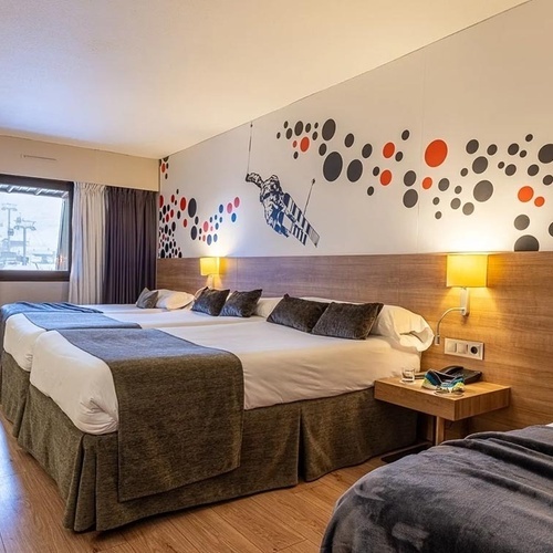 a hotel room with three beds and a painting on the wall