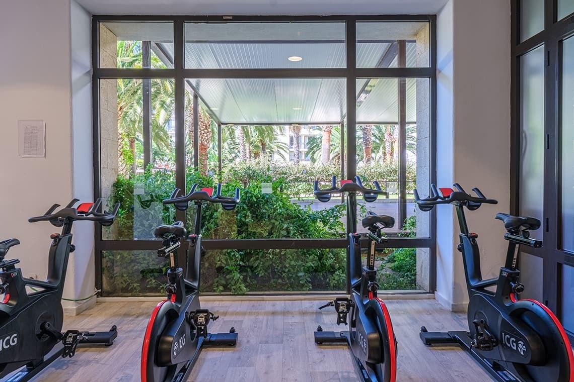 a row of exercise bikes with the letters ccg on them