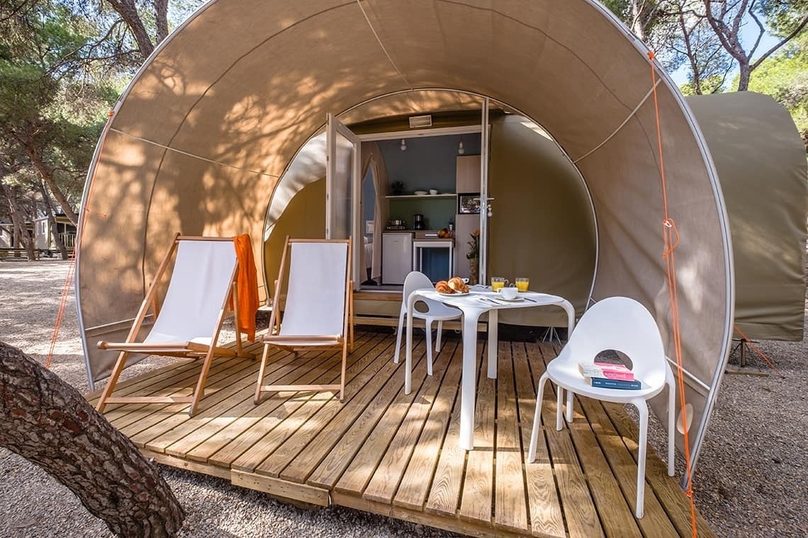 a tent with a table and chairs inside of it