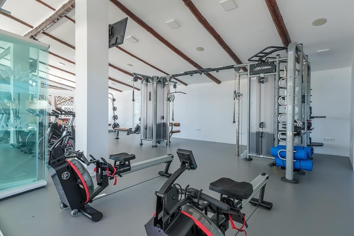una habitación llena de equipos de gimnasio y la palabra life fitness en la pared