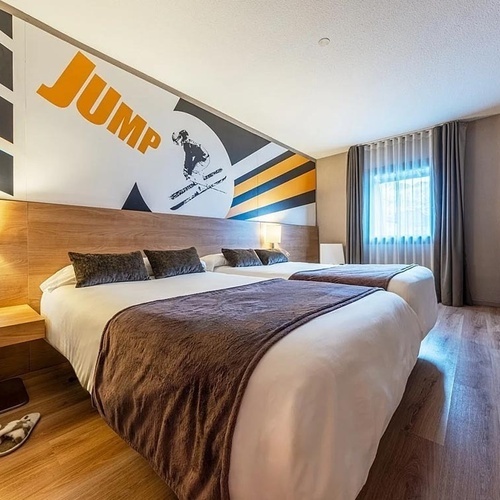 a hotel room with two beds and a sign on the wall that says jump