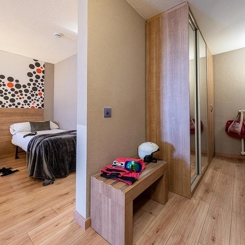 a bedroom with a polka dot wall and a bed