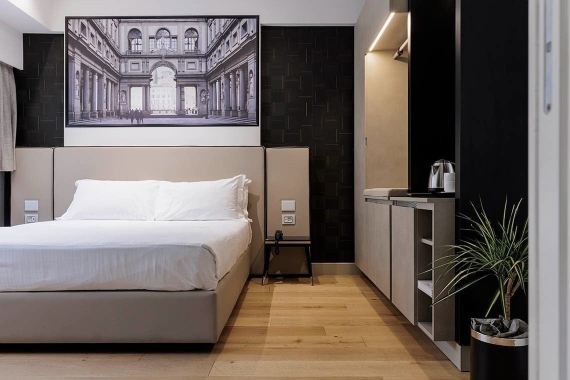 una camera d' albergo con un letto e un dipinto sopra