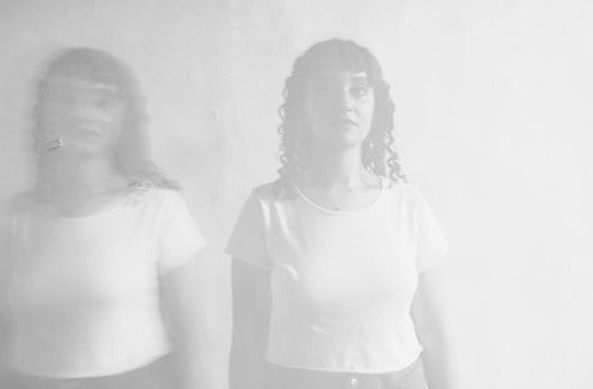 una mesa de madera con comida y una copa de vino