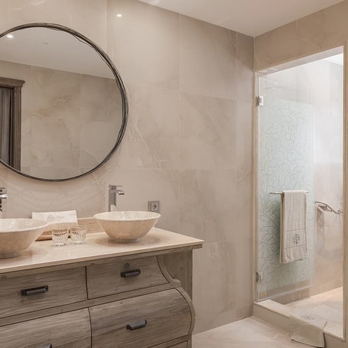 ein Badezimmer mit zwei Waschbecken und einem großen Spiegel