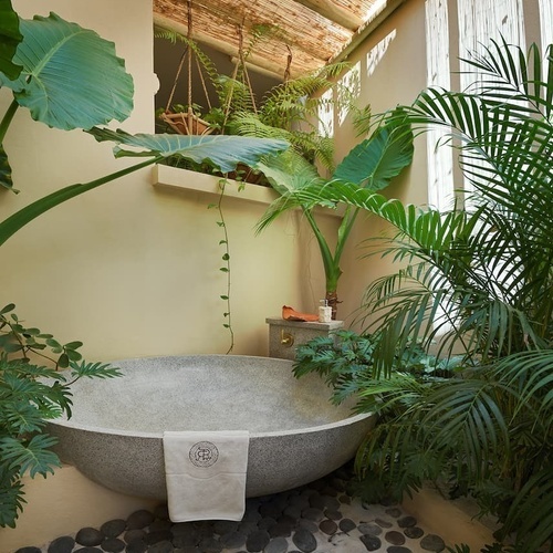 ein Badezimmer mit einer großen Badewanne und Pflanzen