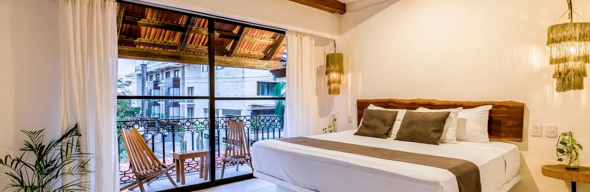 a bedroom with a large bed and a balcony