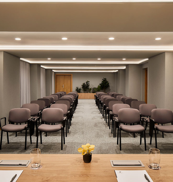 a conference room with rows of chairs and a table