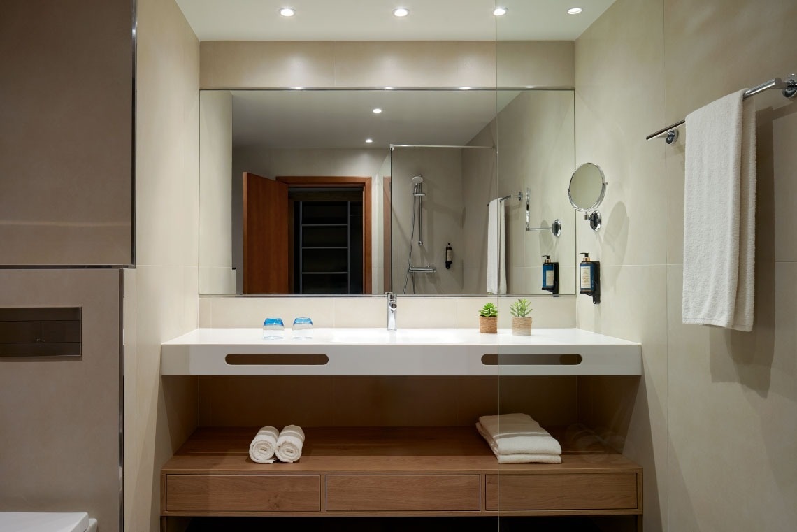 a bathroom with two sinks and a large mirror