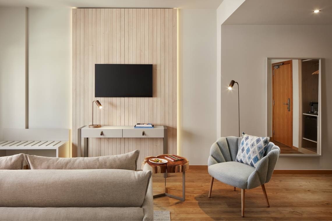 a living room with a couch a chair and a flat screen tv