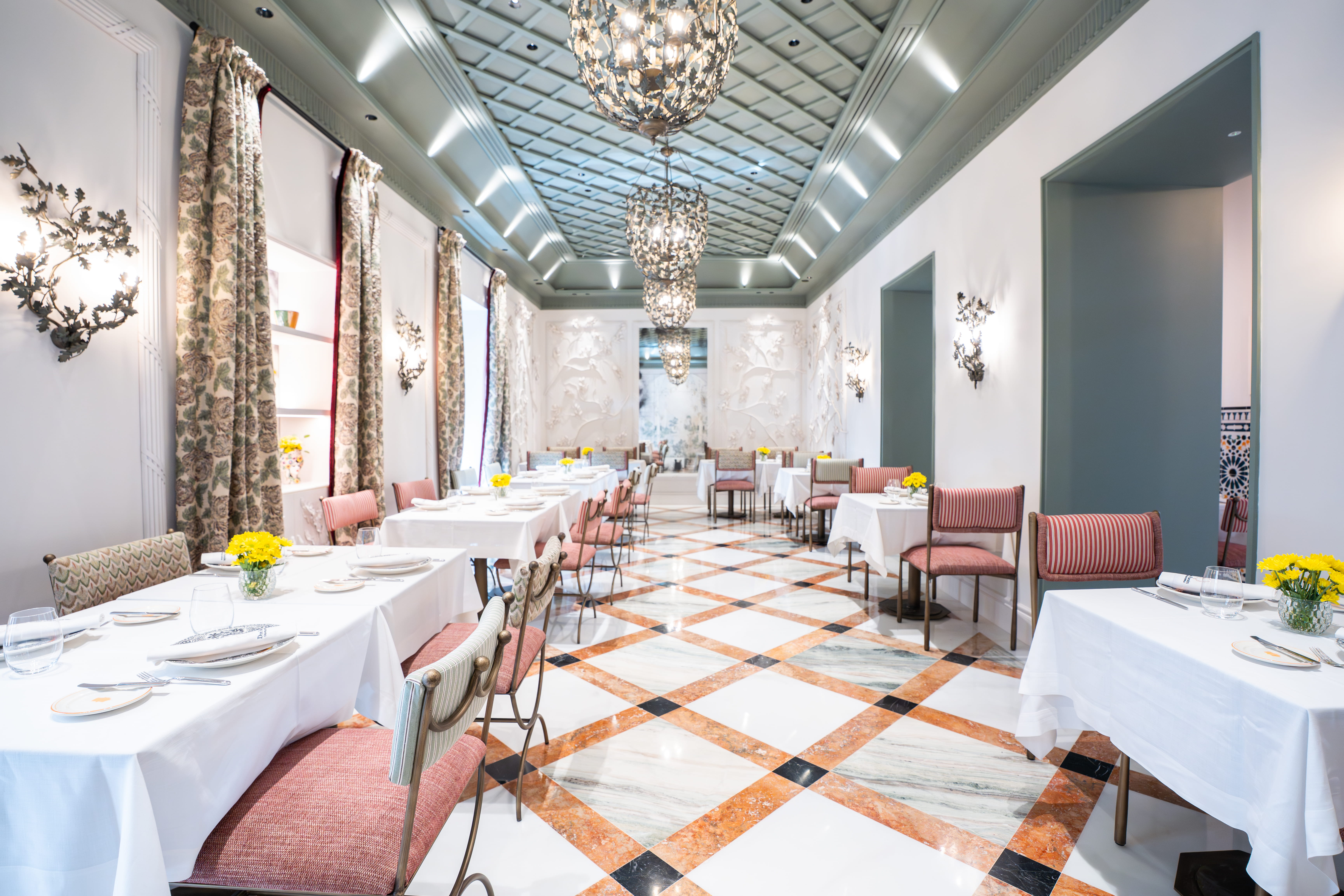 Rooftop lounge with seating, plants, and beautiful tile flooring at Hotel Don Ramón 5 GL.