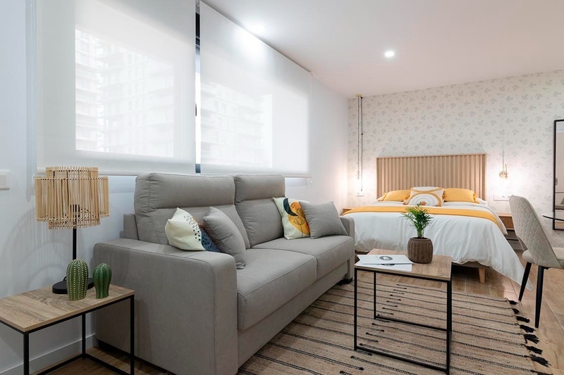 una cama con sábanas blancas y almohadas blancas