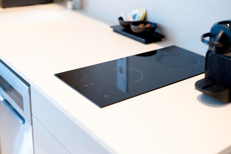 una cama con sábanas blancas y almohadas blancas