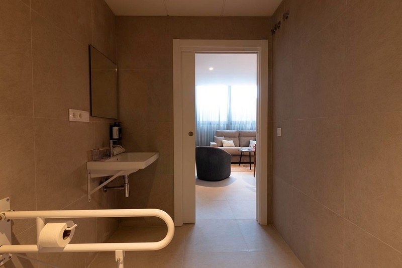 una cama con sábanas blancas y almohadas blancas