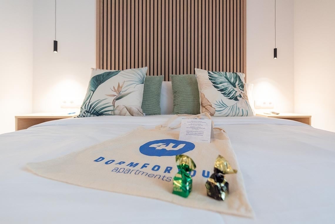 una cama con una bolsa de dormfortu apartamentos encima