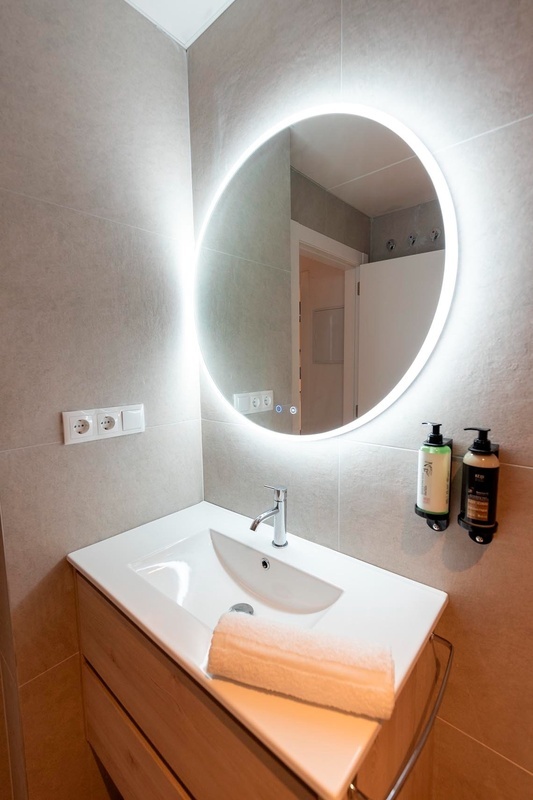 una cama con sábanas blancas y almohadas blancas