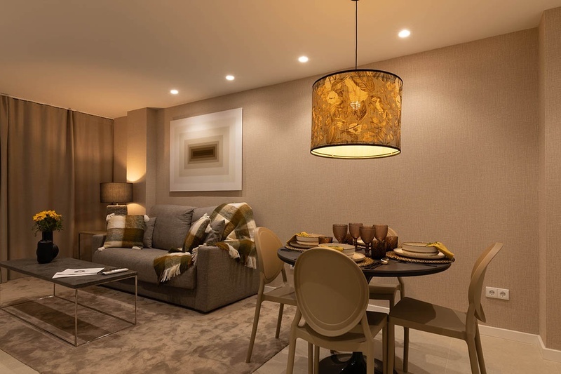 a bed with white sheets and pillows in a hotel room