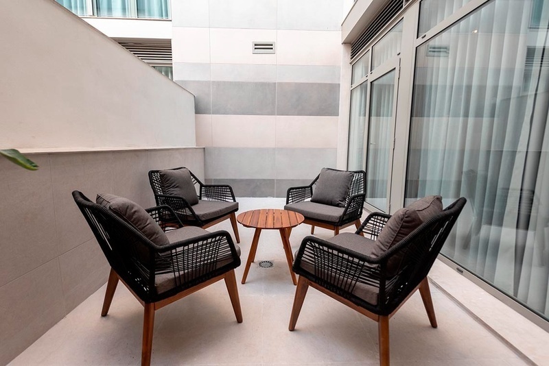 una cama con sábanas blancas y almohadas blancas