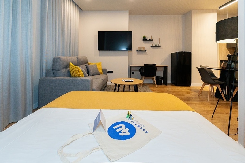 una habitación con una cama y un árbol en la pared