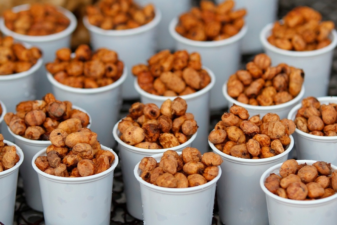 a bunch of cups filled with nuts on a table