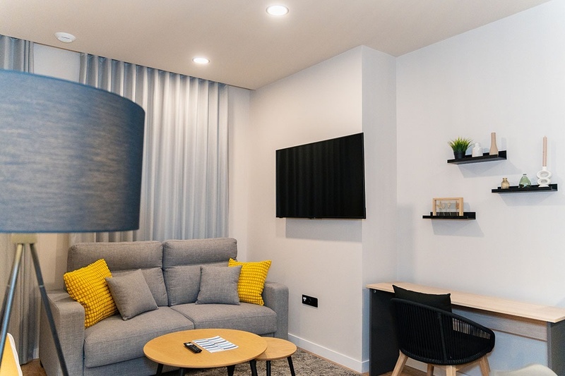 una habitación con una cama y un árbol en la pared