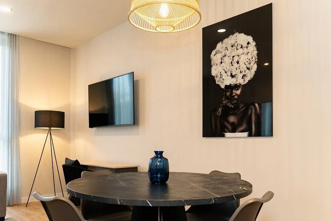 una mesa y sillas en una habitación con una pintura en la pared