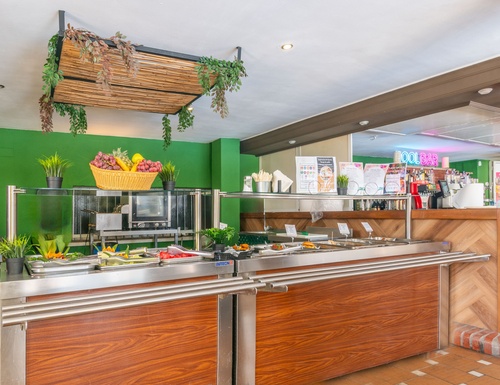 a buffet line in a restaurant with a sign that says ' coca cola ' on it