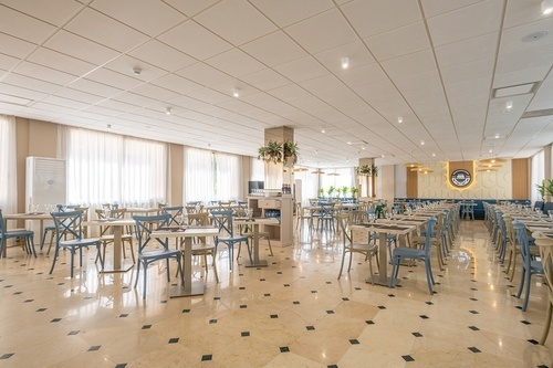 a large dining room with tables and chairs and a sign that says coffee