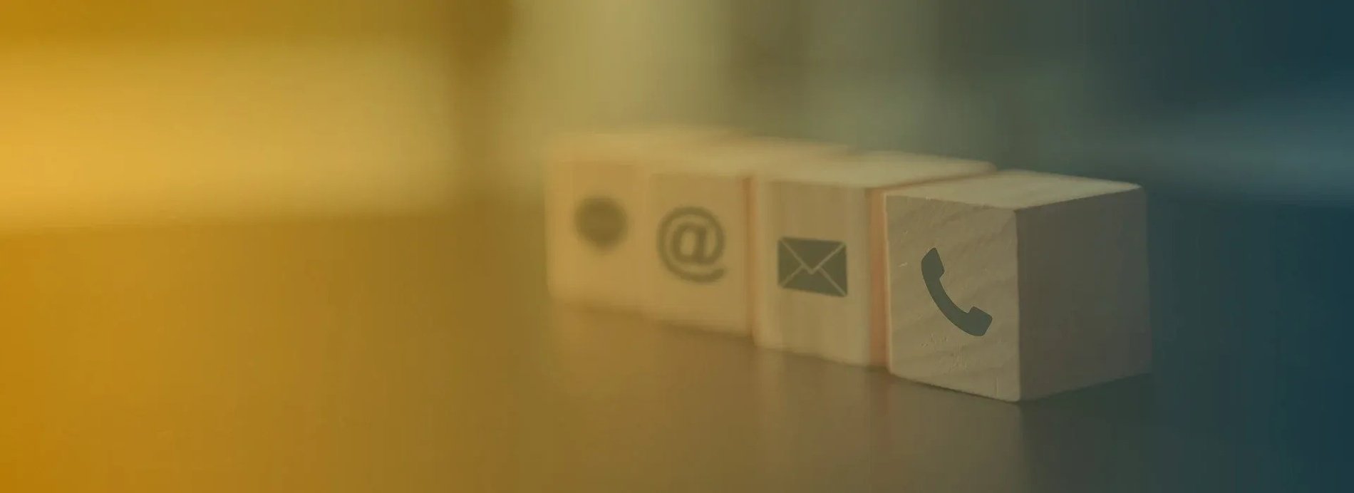 a row of wooden blocks with contact icons on them