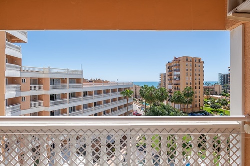 a balcony with a view of a city and the ocean