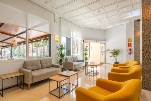 a hotel lobby with a fire extinguisher on the wall