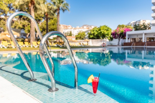Modern rooftop terrace with sun loungers & sea views at San Fermín by Dorobe Hotels, Torremolinos.