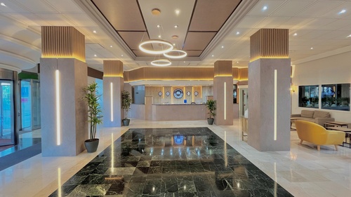 a lobby of a hotel with clocks on the wall