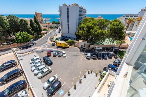 Sunny view from San Fermín by Dorobe Hotels, Torremolinos, with parking and sea backdrop.