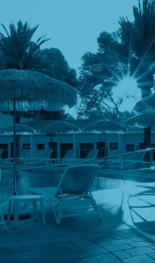 the sun is shining through the umbrellas and chairs