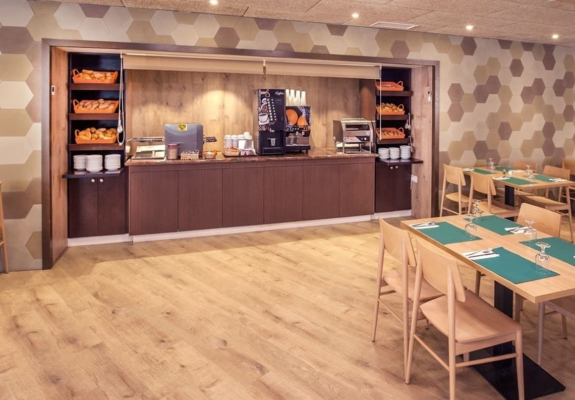 a dining room with tables and chairs and a coffee machine that says ' cafe ' on it