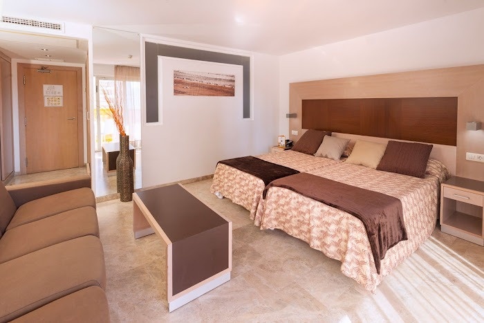 a hotel room with two beds and a couch