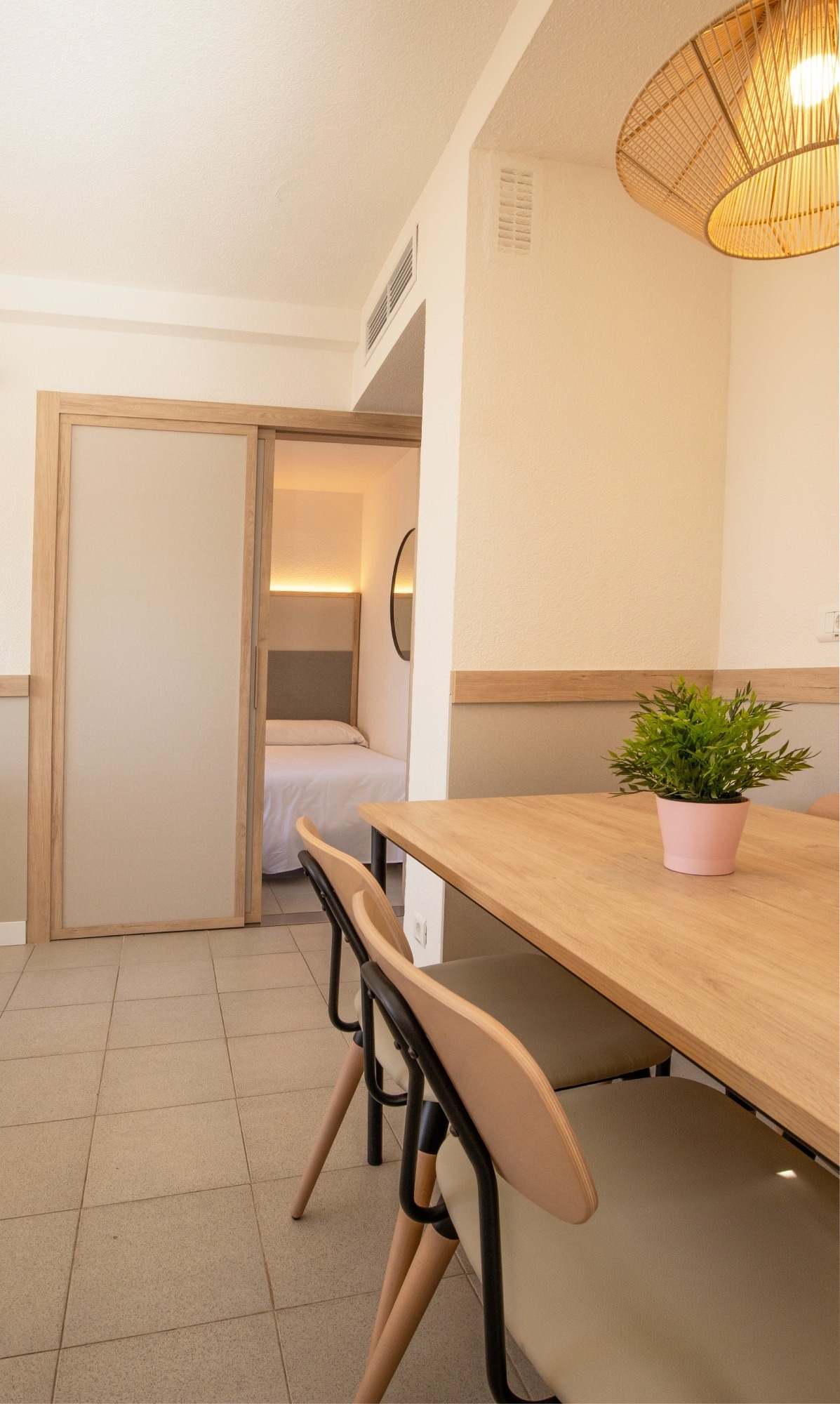 a room with a table and chairs and a plant on it