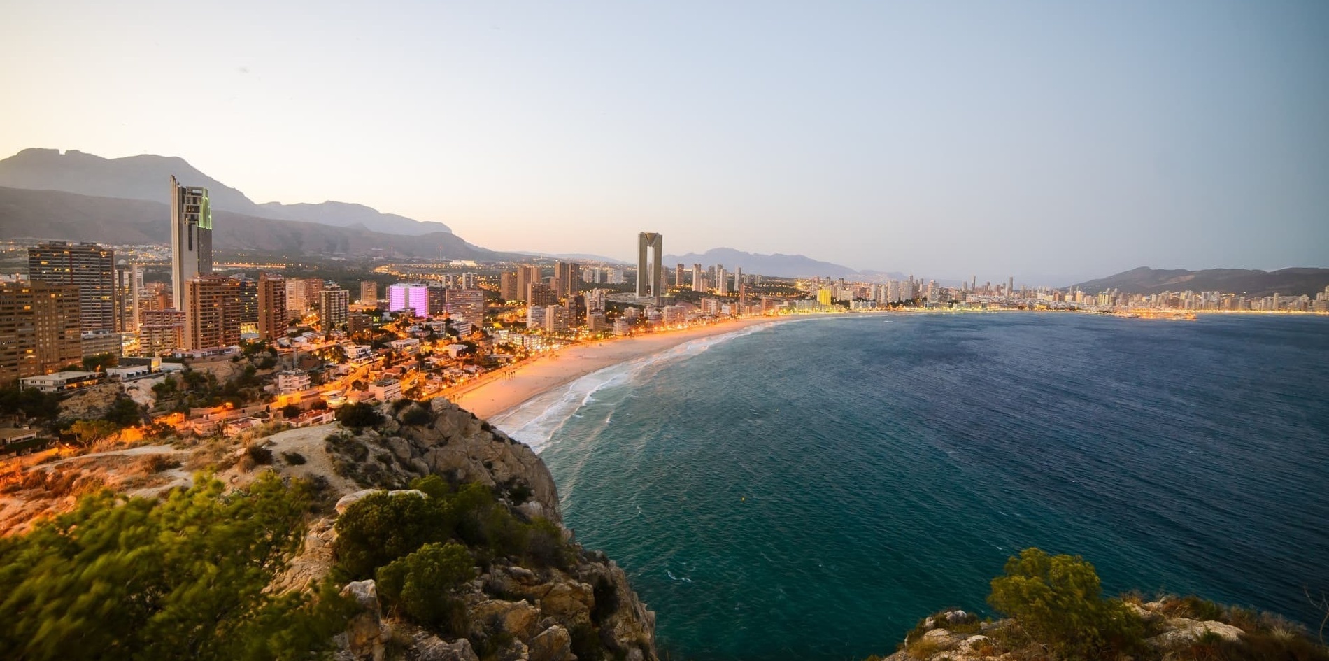 a large body of water with a city in the background