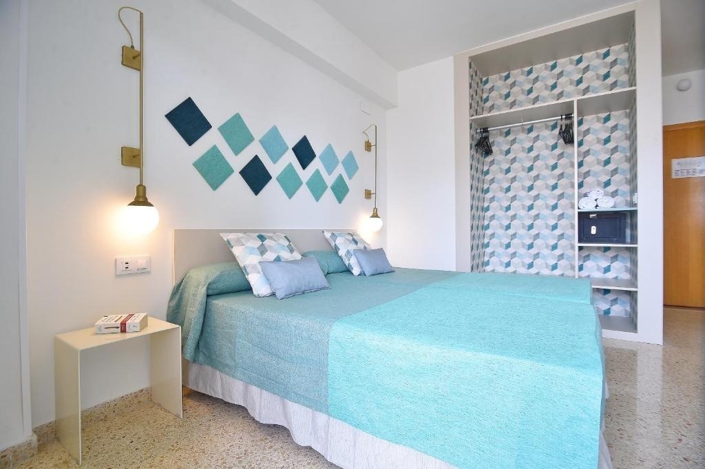 a bedroom with a bed and a book on a nightstand