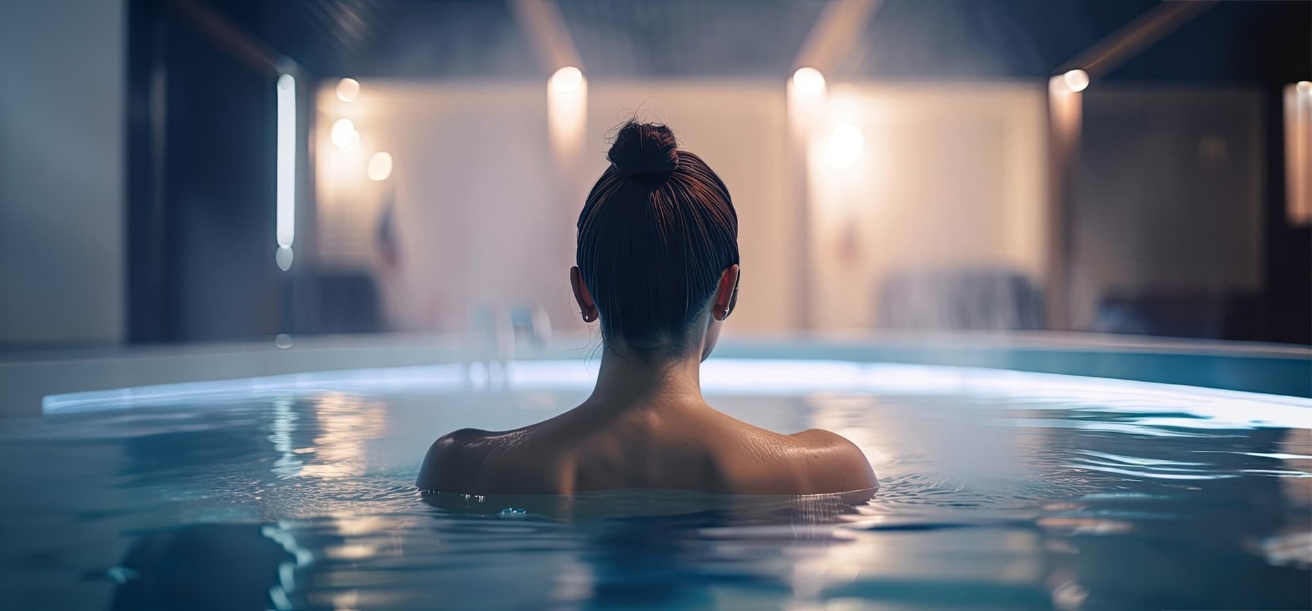 a woman is taking a bath in a hot tub