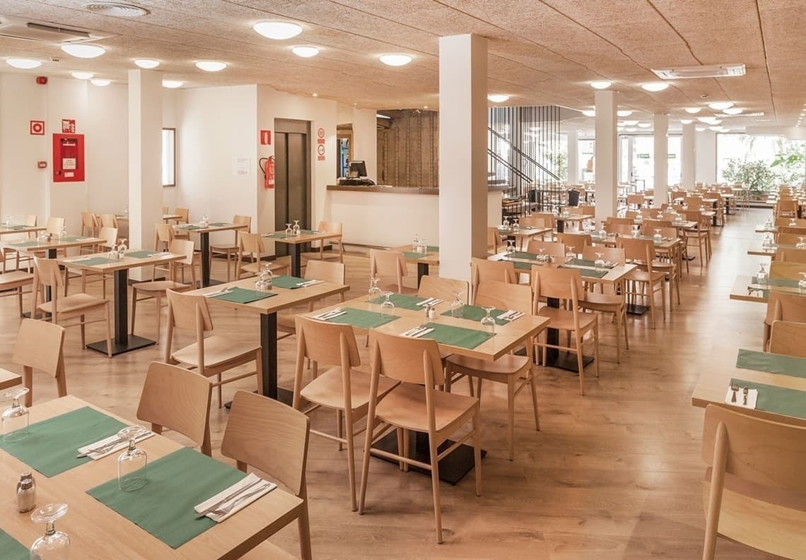 a restaurant with tables and chairs and a fire extinguisher on the wall