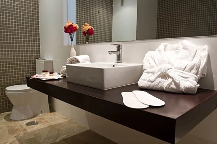 a bathroom with a sink and a robe on the counter