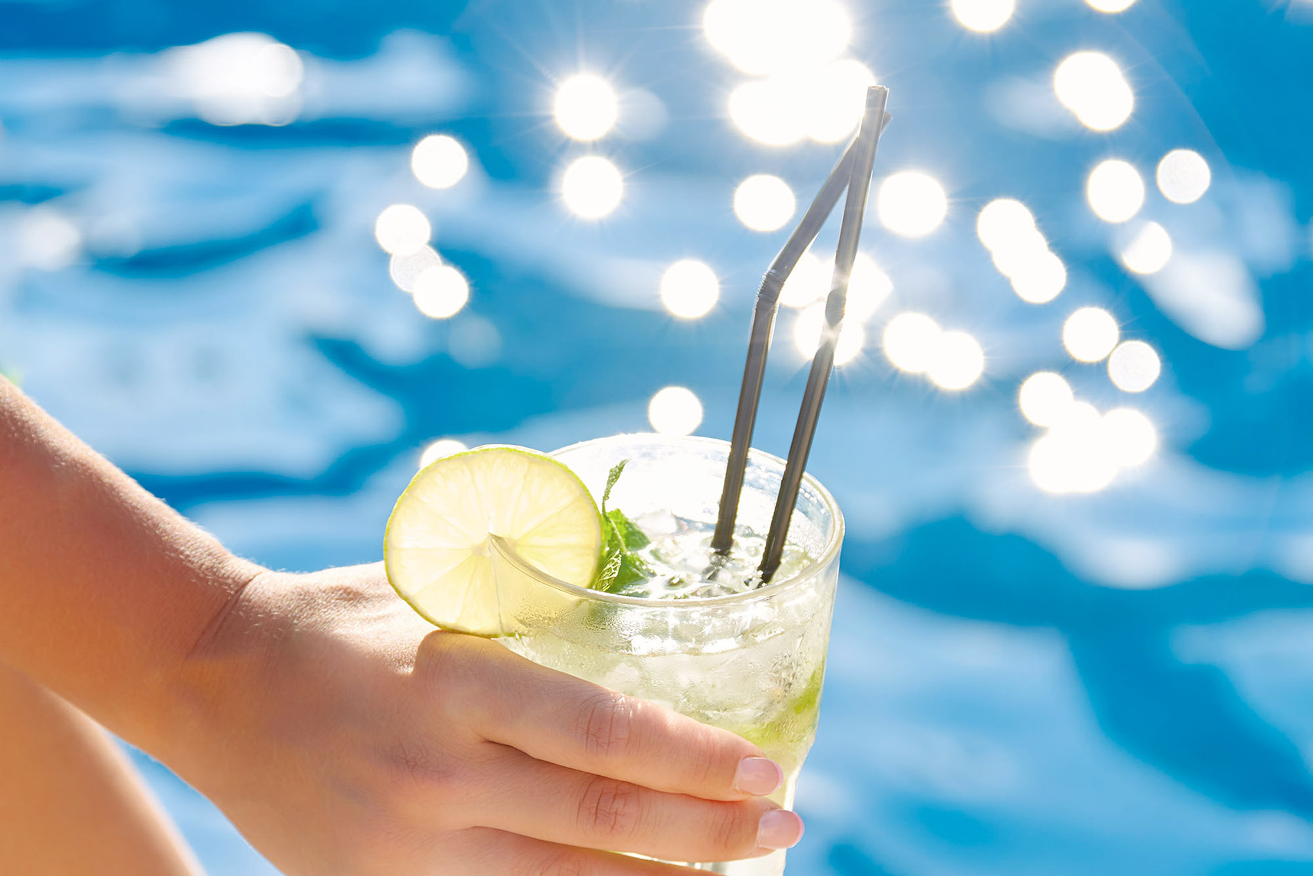 Enjoy a refreshing cocktail with lime by the pool