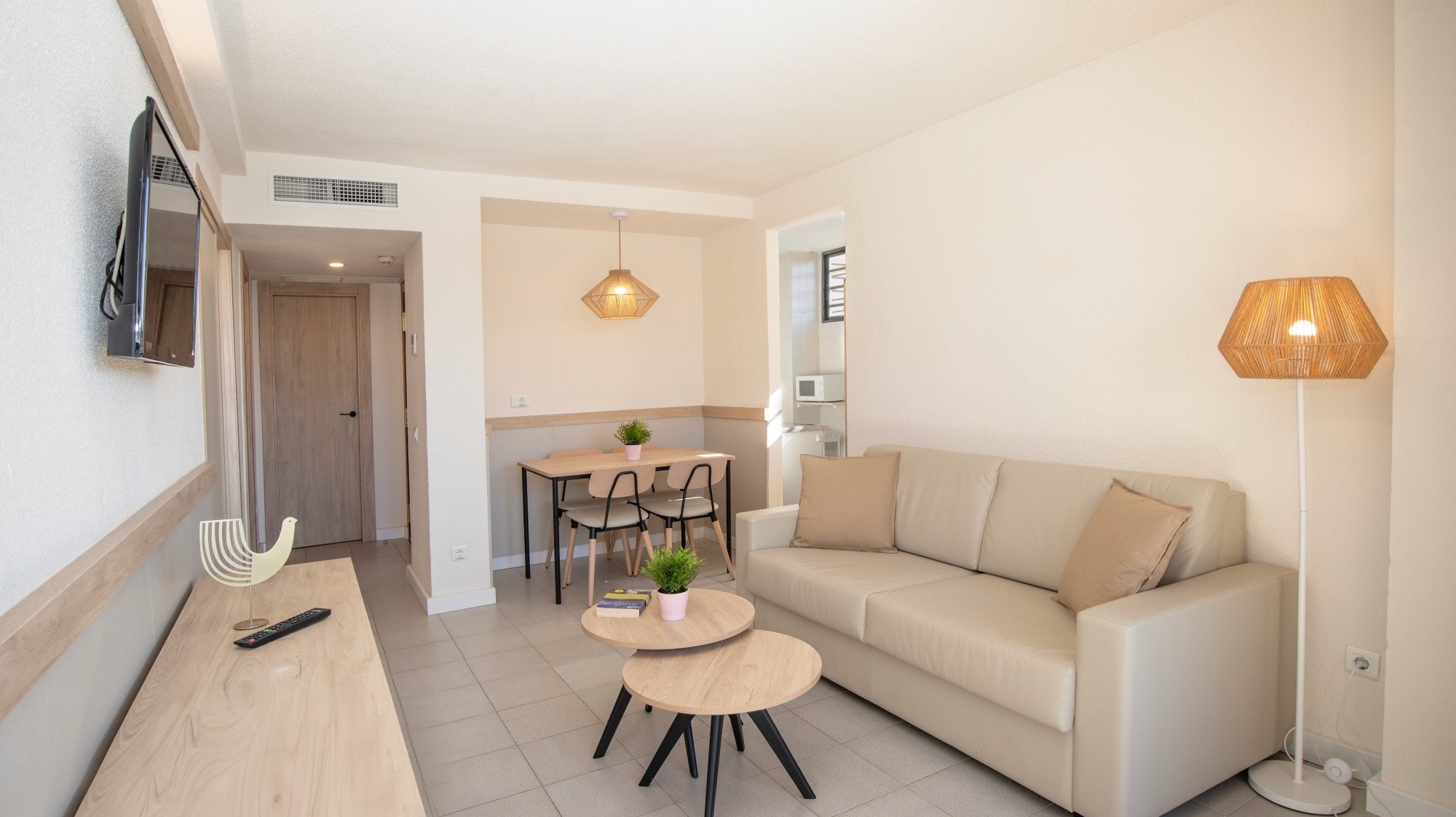 a living room with a couch a table and a lamp