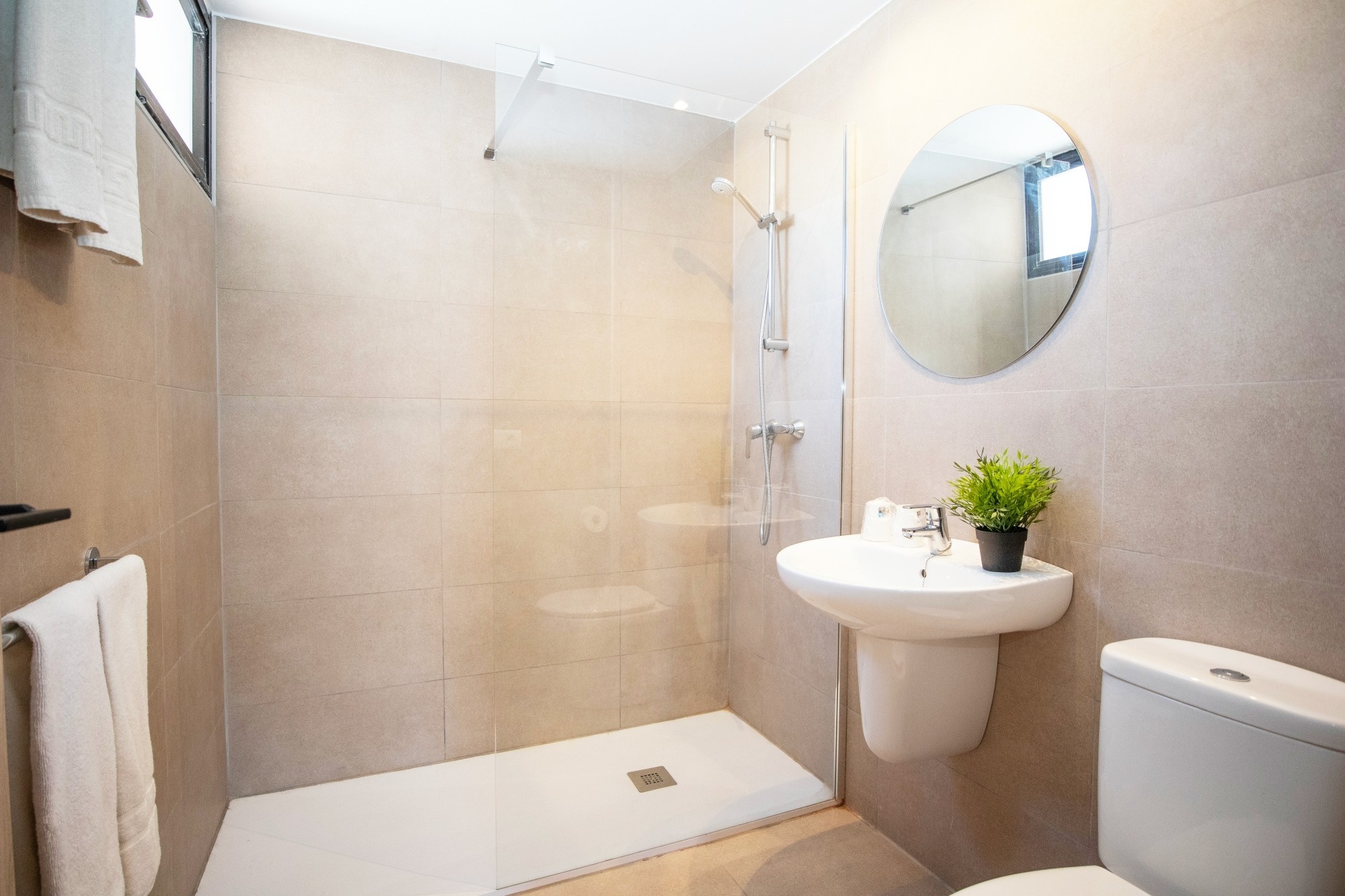 a bathroom with a walk in shower and a sink